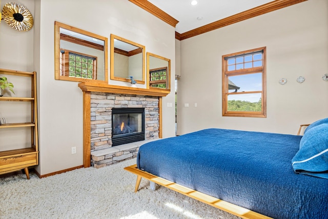 carpeted bedroom with ornamental molding and a stone fireplace