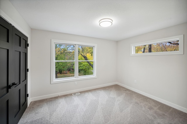 empty room featuring light colored carpet