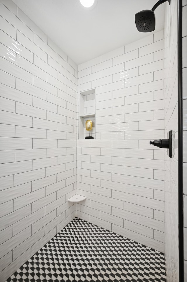 bathroom with a tile shower