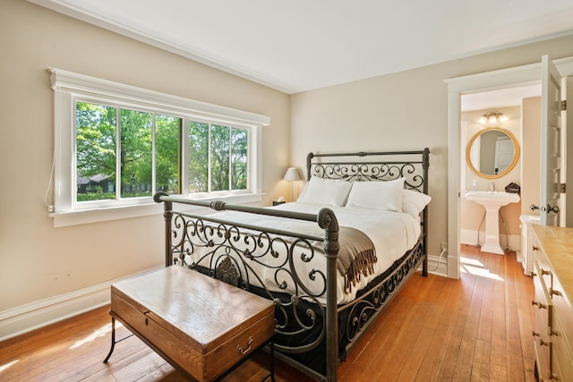 bedroom featuring sink and light hardwood / wood-style floors