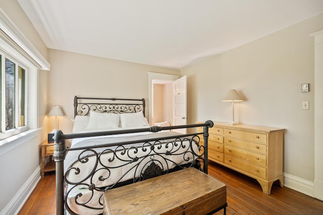 bedroom with dark hardwood / wood-style floors