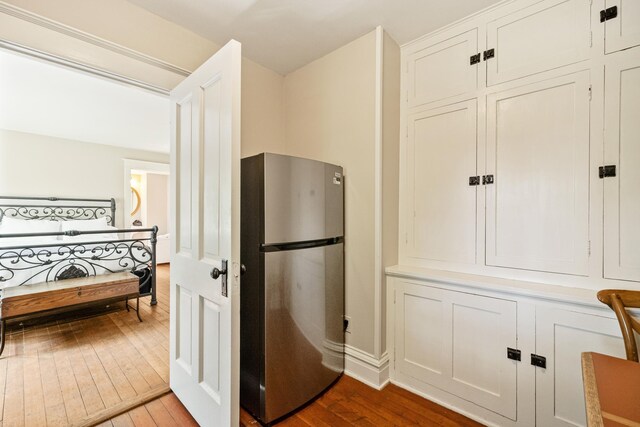 2799 27th St Unit 14, Gardeners, Birchwood, WI 54817 - kitchen featuring freestanding refrigerator, hardwood / wood-style floors, and white cabinetry