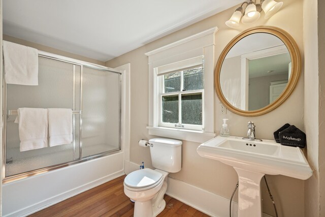 2799 27th St Unit 14, Gardeners, Birchwood, WI 54817 - bathroom featuring toilet, wood finished floors, combined bath / shower with glass door, and baseboards