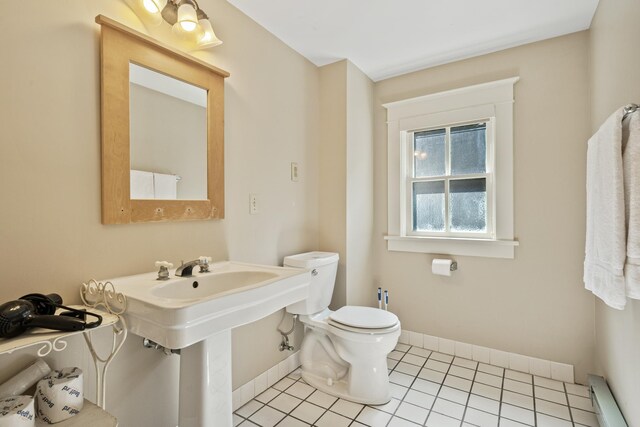 2799 27th St Unit 14, Gardeners, Birchwood, WI 54817 - half bathroom featuring baseboards, toilet, baseboard heating, and tile patterned floors