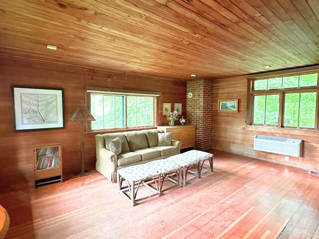2799 27th St Unit 14, Gardeners, Birchwood, WI 54817 - living room with healthy amount of natural light, an AC wall unit, wooden ceiling, wooden walls, and wood-type flooring