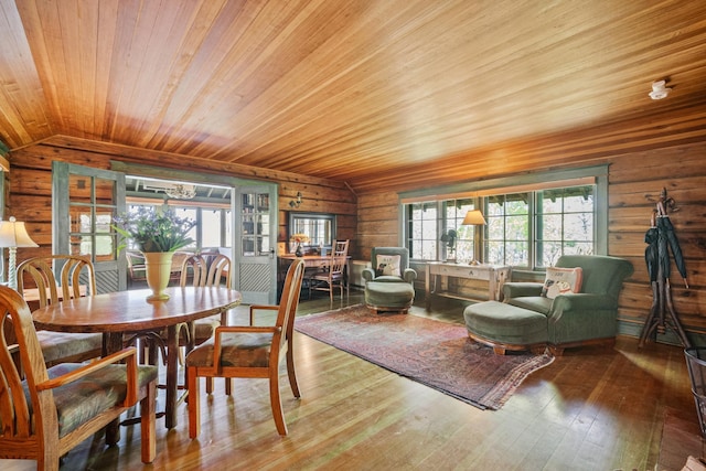 dining room with lofted ceiling, hardwood / wood-style flooring, wooden walls, and wooden ceiling