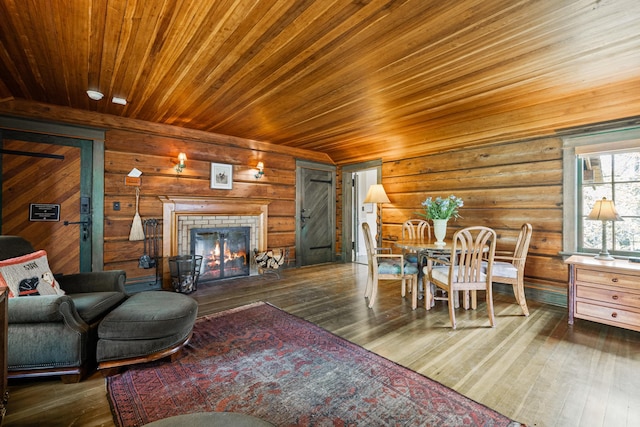 living room with a fireplace, dark wood-type flooring, and wooden ceiling