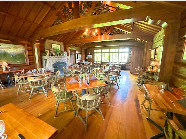 2799 27th St Unit 8, Katherine, Birchwood, WI 54817 - dining area featuring wooden walls, hardwood / wood-style flooring, and a fireplace