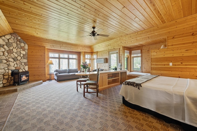 bedroom with wooden walls, multiple windows, and wooden ceiling