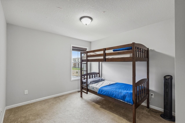 bedroom with carpet and a textured ceiling