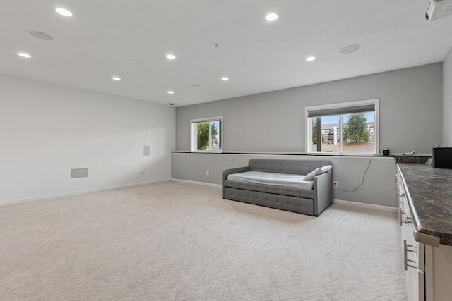 living room with plenty of natural light and light colored carpet