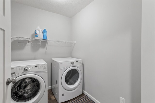 laundry area featuring separate washer and dryer and a textured ceiling