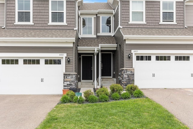 view of front of house featuring a garage and a front lawn