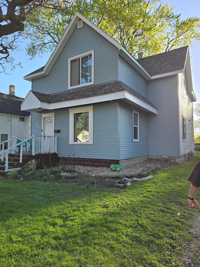 back of property featuring a yard