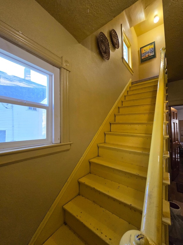 staircase featuring a wealth of natural light