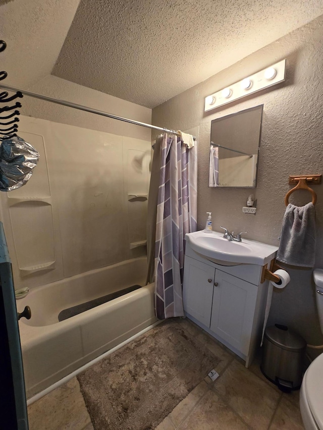 full bathroom featuring shower / bath combo with shower curtain, tile floors, vanity, toilet, and a textured ceiling