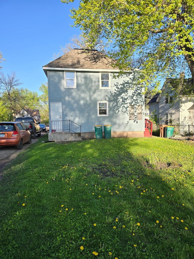 back of house with a lawn