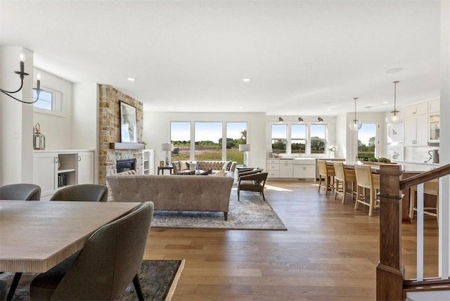 living room with a chandelier, a fireplace, and dark wood-type flooring