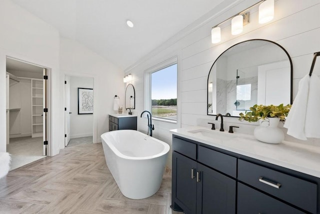 bathroom featuring vanity, lofted ceiling, and independent shower and bath