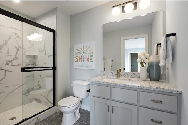 bathroom with tile patterned flooring, vanity, toilet, and a shower with door