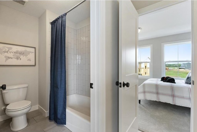 bathroom with shower / bath combo with shower curtain and toilet