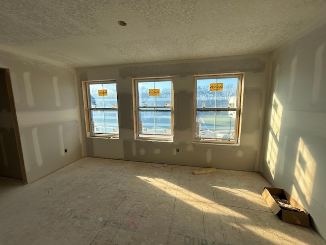 spare room with a textured ceiling