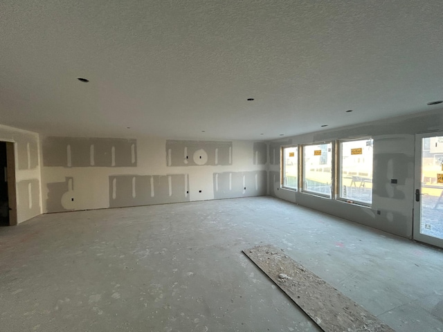 unfurnished living room featuring a textured ceiling