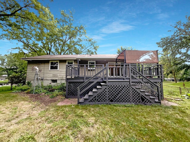 rear view of house featuring stairs, a deck, and a yard