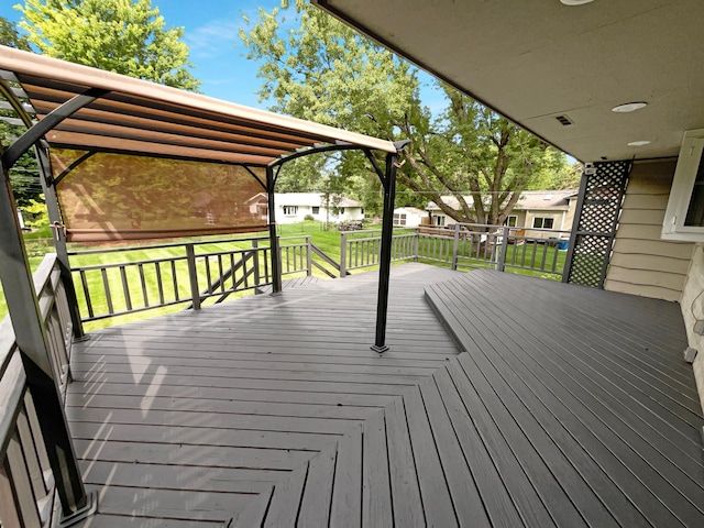 wooden deck featuring a lawn