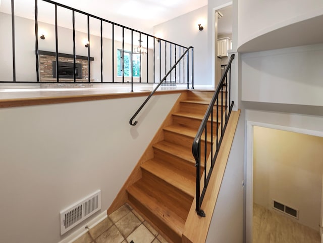 stairs featuring visible vents and tile patterned floors