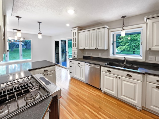 kitchen with dark countertops, white cabinets, and dishwasher