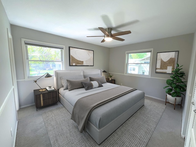 bedroom featuring light carpet, a ceiling fan, and baseboards