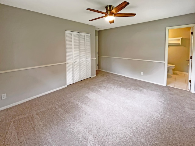 unfurnished bedroom with carpet floors, a closet, and baseboards