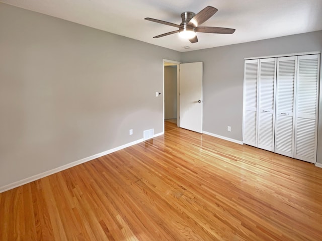 unfurnished bedroom with visible vents, baseboards, a ceiling fan, light wood-style flooring, and a closet