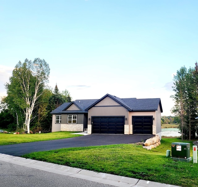 view of front facade with an attached garage, driveway, stone siding, board and batten siding, and a front yard