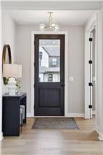 entrance foyer with wood-type flooring and an inviting chandelier