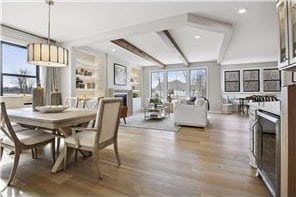 dining room with wood-type flooring and beam ceiling