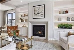 living room with built in features and light hardwood / wood-style floors