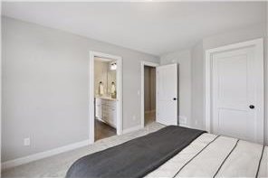 unfurnished bedroom with carpet and ensuite bathroom