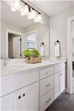 bathroom with oversized vanity and dual sinks