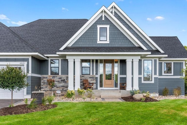 craftsman-style home with a front yard and a garage