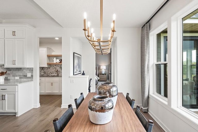 dining space with a notable chandelier and hardwood / wood-style flooring