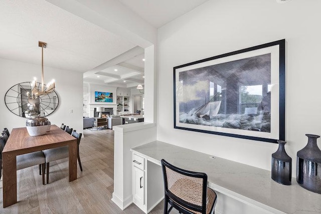 interior space with hardwood / wood-style flooring, coffered ceiling, an inviting chandelier, and beamed ceiling