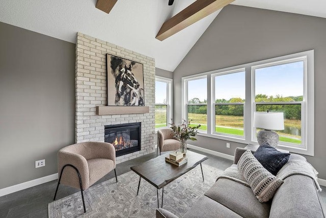 living room featuring a fireplace, high vaulted ceiling, dark tile flooring, brick wall, and beam ceiling