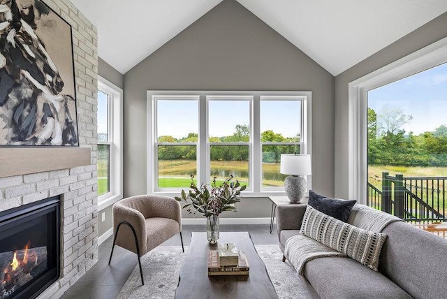 interior space featuring lofted ceiling, a healthy amount of sunlight, and a fireplace