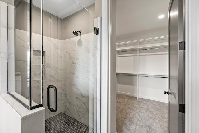 bathroom featuring a shower with door