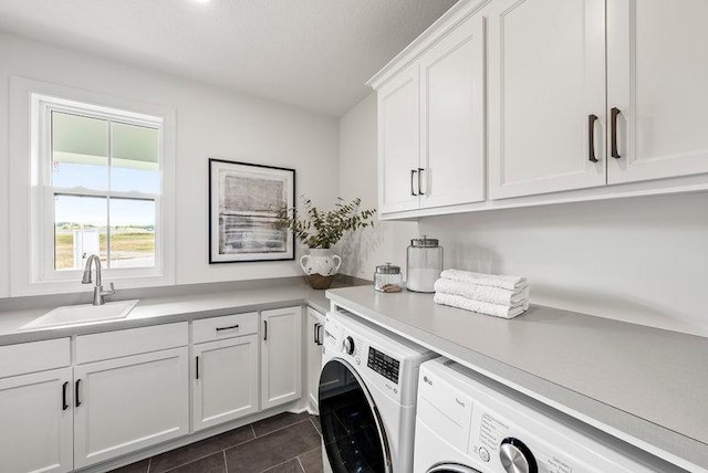 clothes washing area featuring sink, independent washer and dryer, cabinets, and dark tile floors