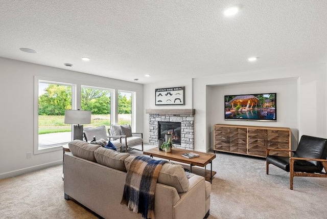 carpeted living room featuring a fireplace and a textured ceiling