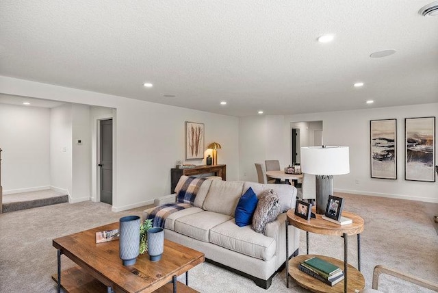 living room with a textured ceiling and carpet