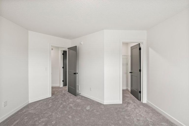 unfurnished bedroom featuring carpet and a textured ceiling